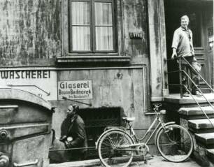 Milieuaufnahme. Wohnquartier in Hamburg. Typische Straßenszene. Wie früher üblich, befanden sich im Kellerbereich der Mietshäuser kleine Geschäfte oder Werkstätten