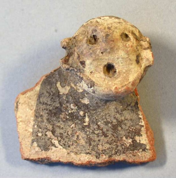 Clay head (fragment of a burial urn)