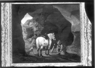 Reiter mit Schimmel und Hund in einer Höhle