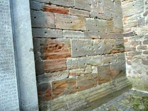 Freienhagen-(Evangelische Kirche) - Kirchturm von Süden - Erdgeschoß im Südsüdosten-Wetzrillen im Werkstein (symbolisches Entschärfen der Dolche)