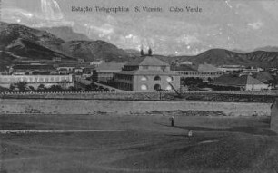 Mindelo : Ansichtskarte mit Blick auf ein Fabrikgebäude in Mindelo mit Berglandschaft im Hintergrund.