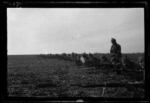 Nicht identifizierbare Gegend in Nordfrankreich oder Belgien: Soldaten auf einem Feld beim Liegendschießen (Nahaufnahme) ("Schützenlinie" - "Übung")