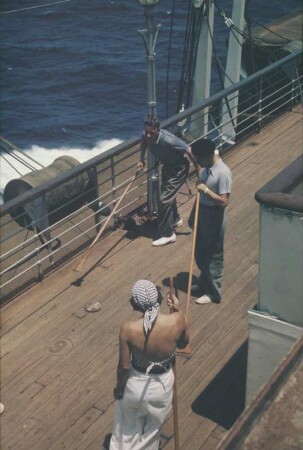 Bordleben Cap Arcona. Passagiere spielen auf dem Oberdeck des Passagierschiffes Shuffleboard