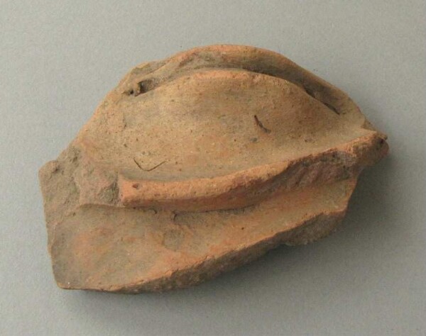 Clay face (fragment)