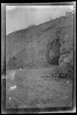 Prémesques (?) (Dep. Nord, Frankreich): hohe bogenförmige Öffnung unterhalb eines Erdhügels (Distanzaufnahme) ("vermutlich Fort Prémesques")