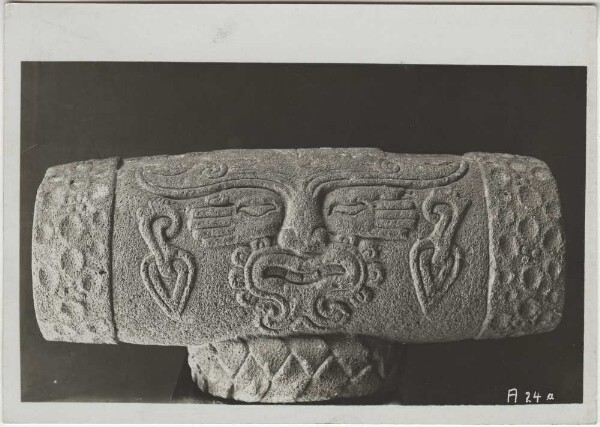 Ancient stone replica of a teponaztli (wooden drum) resting on a bast curl with a relief depicting the god of play and dance (flower god) Macuilxochitl. Guillermo de Heredia Collection.