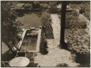 Garten Luise Monscheuer, Berlin-Lichterfelde: Wasserbecken am Weg, weiße Gartenmöbel