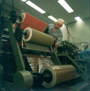 Magnetband-Herstellung (Ludwigshafen BASF-Werk ?). Magnetrollen werden in Präzisionsmaschinen eingehängt, die die Folienbahnen auf die handelsüblichen Breiten schneiden