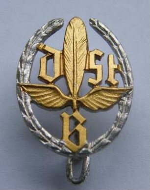 Treueabzeichen in Silber Deutscher Stenografenbund (mit Broschennadel) : Sammlung Beinhorn. Treueabzeichen in Silber Deutscher Stenografenbund (DStB mit geflügelter Feder im Lorbeerkranz, mit Broschennadel). Metall, versilbert; Maße 20,5 x 16 mm (nach 1960). Dresden: SLUB R c 0219