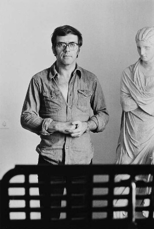Der Grafiker Walter Herzog neben einer Skulptur