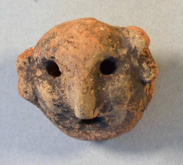 Clay head (fragment of a burial urn)