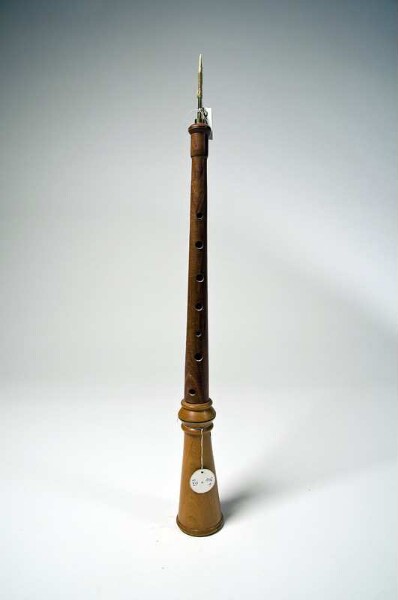 Oboe with conical tube with finger holes and mouthpiece with reed