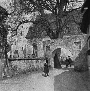 Torbogen zu einem Kirchhof mit Kindern