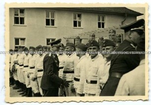 Luftwaffen-Offiziere gratulieren Rekruten im Drillich