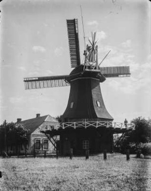 Windmühle : Windmühle in Ostfriesland, auf dem Umlauf ein Mann