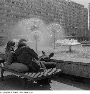 Wasserspiel mit Pusteblumen (Kugelbrunnen) : Dresden. Sich ausruhendes Pärchen am Brunnenrand der Wasserspiele "Pusteblumen"