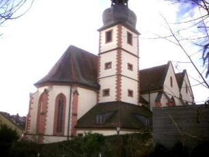 Ansicht von Nordosten mit Kirche (im Baubestand Gotisch auf Romanischem Vorgänger - Langhaus 1906-07 erweitert) über Kirchhofmauer (Wehrgang 1907 abgetragen)