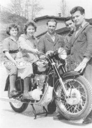Gruppe von Arbeitern mit einem Motorrad