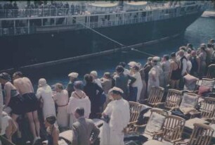 Bordleben. Oberdeck eines Passagierschiffes. Passagiere betrachten einen vorbeifahrenden Liner
