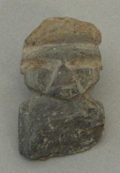 Upper part of a stone figure