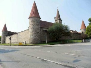 Ansicht von Nordosten mit Südost- Nordost- und Nordwest-Rundturm sowie Kirche über Kirchhofmauer in Übersicht