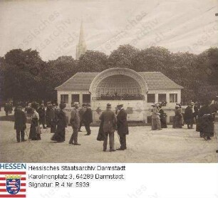 Bad Nauheim, Kuranlage / Trinkkuranlage - Konzertmuschel mit Kapelle und Kurgästen vor dem Teich - im Hintergrund die Dankeskirche