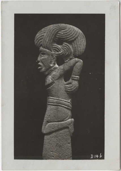 Sacrificed warrior with fantastic headdress. Side view of the stone sculpture. -Palma- Guillermo de Heredia Collection.