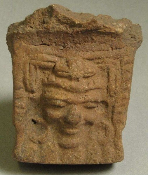 Clay head as vessel base