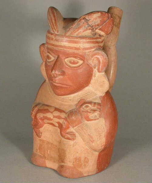 Standing anthropomorphic figure with felids on his arm