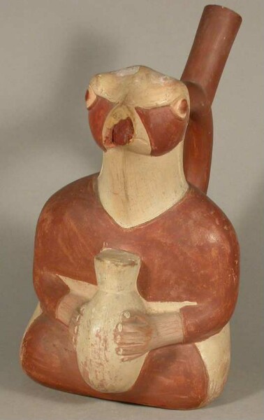 Figure vessel with stirrup spout