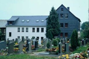 Blick über den Friedhof, dahinter Rüstzeitheim der evangelischen Kirche