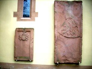 Grabsteine am Langhaus (aus dem aufgelassenen Kirchhof) mit teils noch erkennbaren Umschriften und Wappenkartuschen