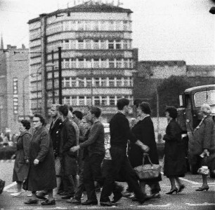 Berlin-Mitte, Alexanderplatz. An einer Ampel die Straße überquerende Fußgänger