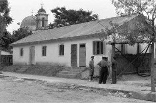 Rumänien. Wohnhaus und dahinter stehende Kirche