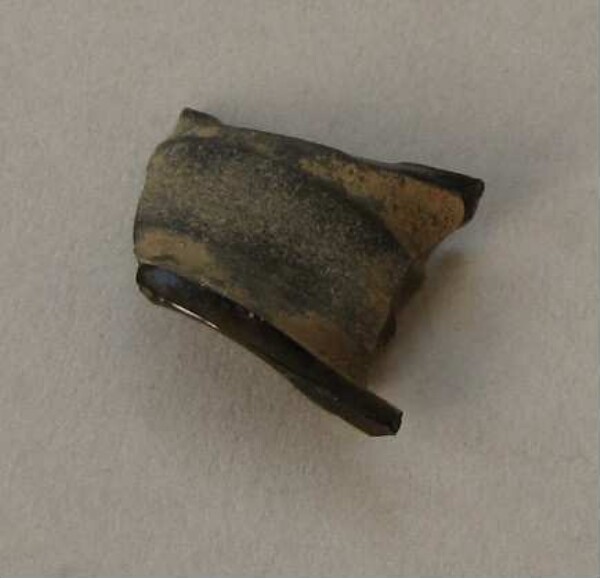 Fragment of an ear peg made of obsidian