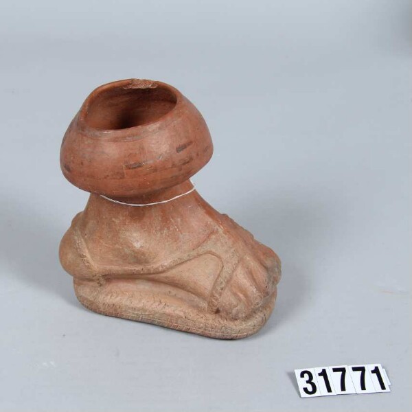 Vessel in the shape of a shod foot