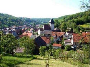 Ansicht von Norden aus erhöhter Umgebung mit Kirchenburg in erhöhter Lage am Ortsrand