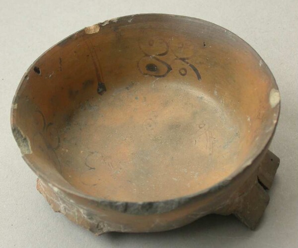 Three-footed clay bowl