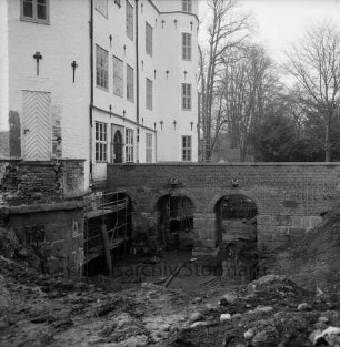 Restaurierung: Brücke vor Eingangsportal nach Wiederherstellung: darunter innerer Graben ausgehoben: Gerüst an Schlossfundament, Gerüstteile