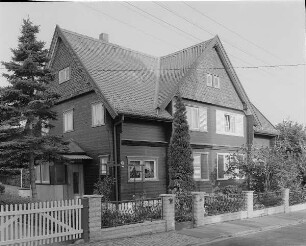 Dresden-Naußlitz, Alfred-Thiele-Straße 12/10. Wohnhaus der Alfred-Thiele-Siedlung, Holzhaussiedlung einer Heimstätten-Genossenschaft (1927; K. Wachsmann). Straßenansicht