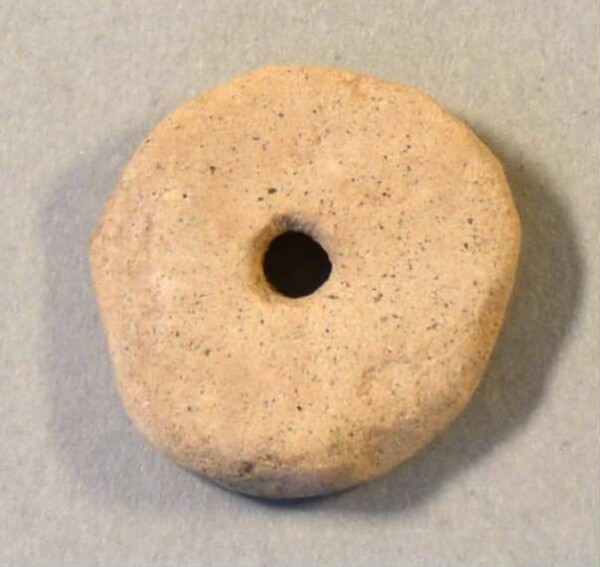 pierced stone disc