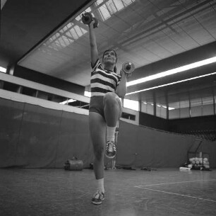 Volleyballtraining der Damen in einer Sporthalle. Training mit Hantel zur Kräftigung der Armmuskulatur