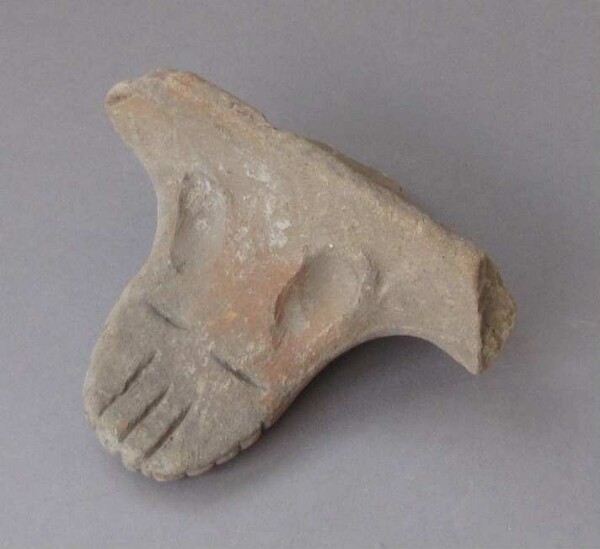 Clay vessel foot (?)