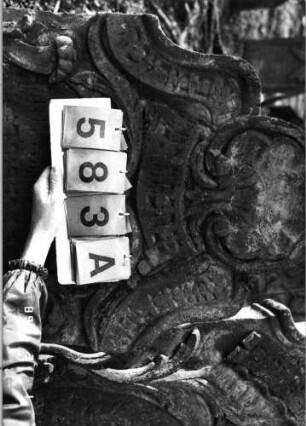 Grabstein 583 (Index: 99753076) Material: Sandstein Zustand: leicht verwittert Maße HxBxT: 116x68x10 cm Beschreibung: Stele, geschwungen eingezog. Rundbogenabschluß, ovales Schriftfeld Symbolik: Muschel, Ranken, Schriftband: Grabstein 583A