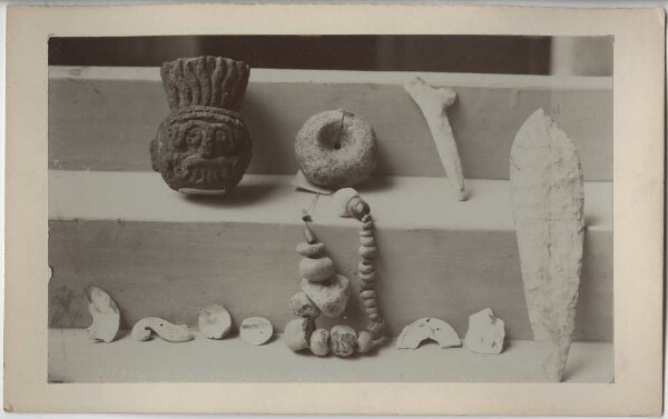 Several objects: stone head, blade, chain, among others.