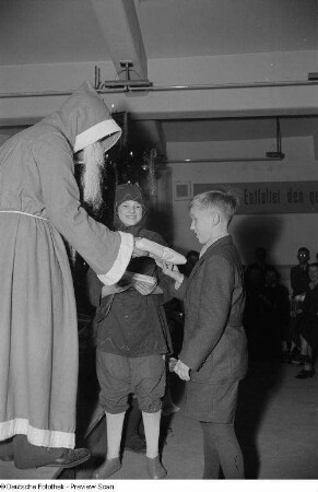 Weihnachtsmann, einem Jungen ein Geschenk überreichend