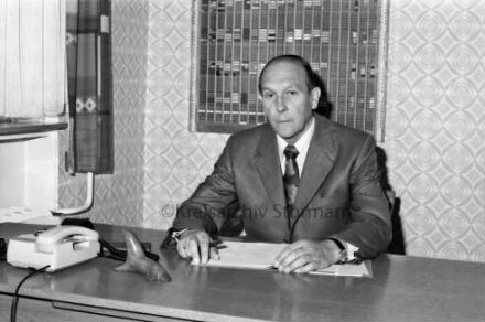 Klaus-Groth-Schule: Königsberger Straße: Rektor Johannes Volkmann: am Schreibtisch, darauf Telefon, Briefbeschwerer: dahinter an Wand Stundentafel: links Fenster