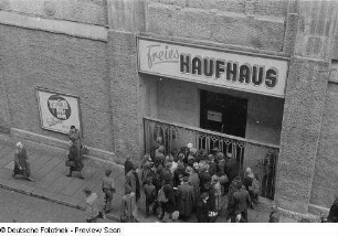 Passanten am Eingang des geschlossenen Kaufhauses