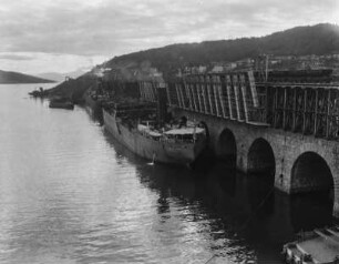 Verladestelle : Blick auf eine Verladestelle mit Brücke und Dampfer.