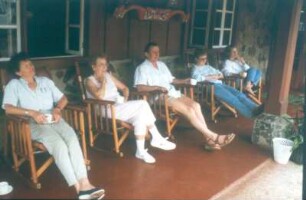 Costa Rica. Touristen in Schaukelstühlen, abends in der Lodge